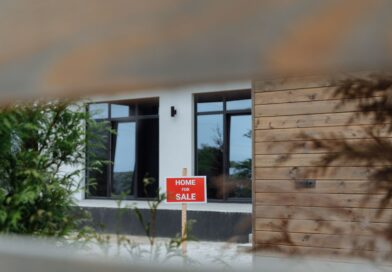 Contemporary home with a Home for Sale sign in the front yard
