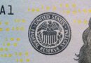 Close-up of the Federal Reserve System seal on a U.S. hundred-dollar bill