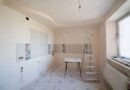 Spacious kitchen under renovation with a ladder and tools