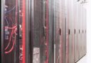 Server racks with red and blue network cables in a modern data center