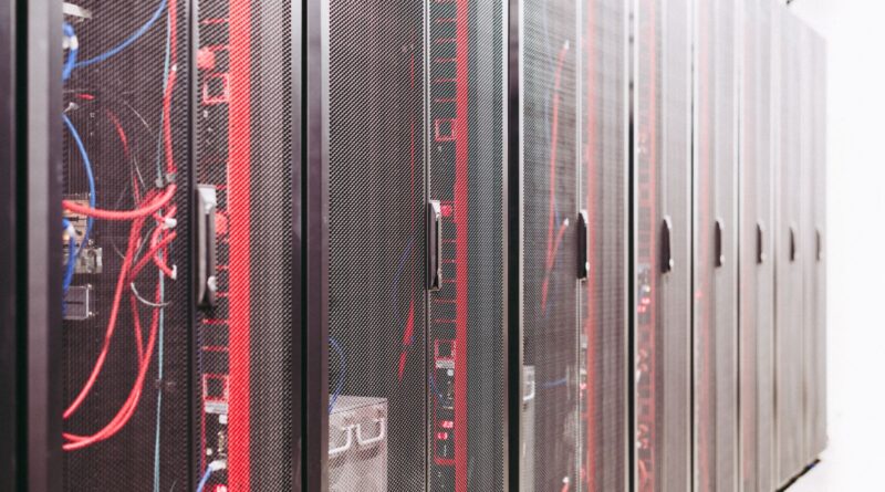Server racks with red and blue network cables in a modern data center